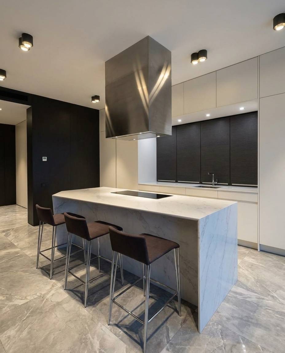 Sleek modern villa kitchen with white marble island and dark bar stools in a renovated Dubai home