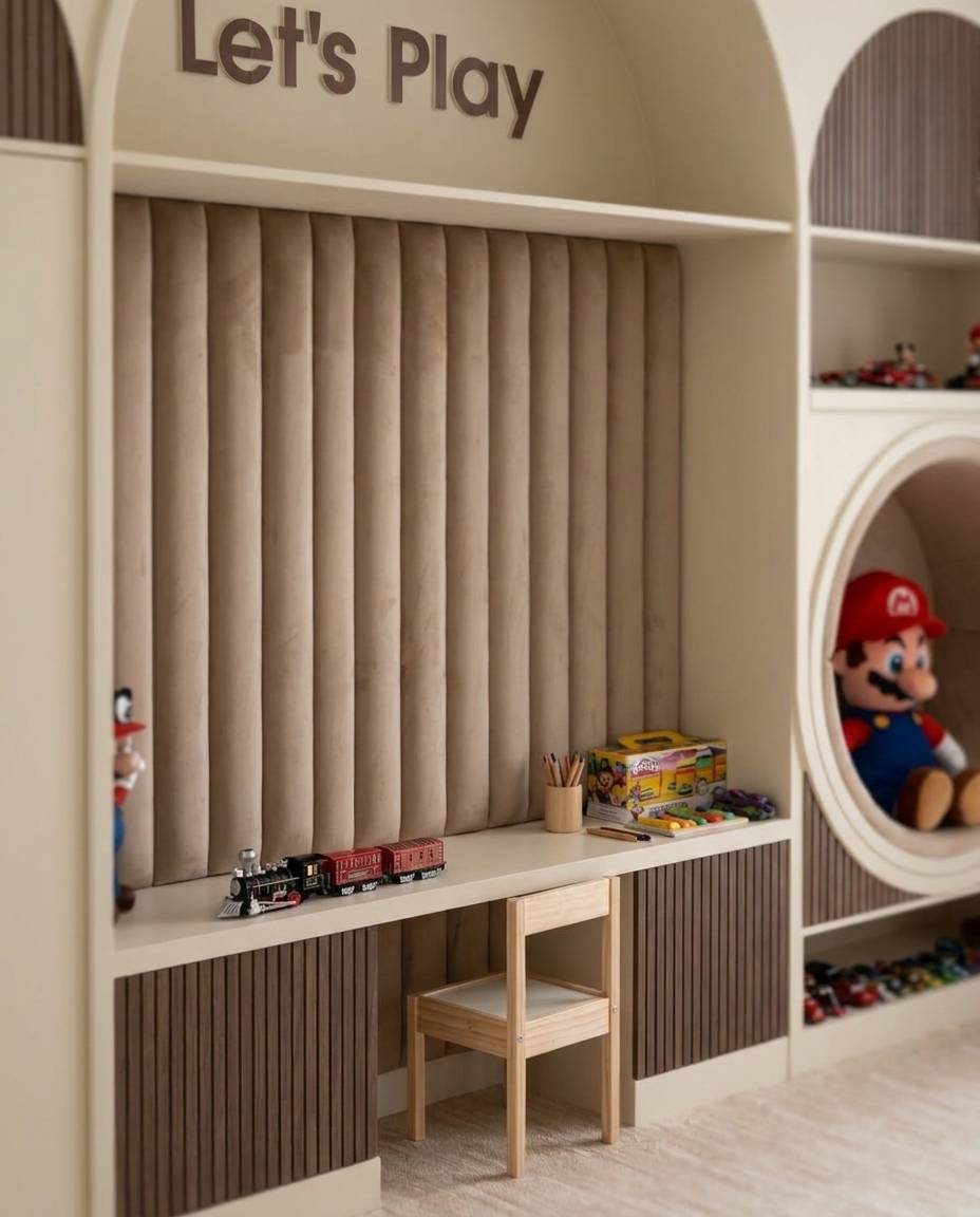 Bespoke light wood kids room joinery with an integrated desk, upholstered back panel and storage in a Dubai playroom.