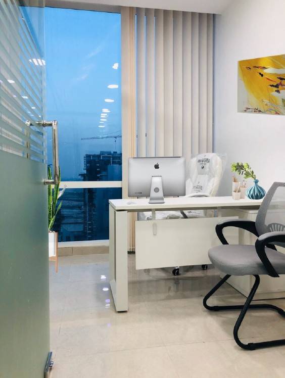 Private office with a glass partition and city view in Business Bay, finished to the same clean lines Noor al Sundus brings to <a href=