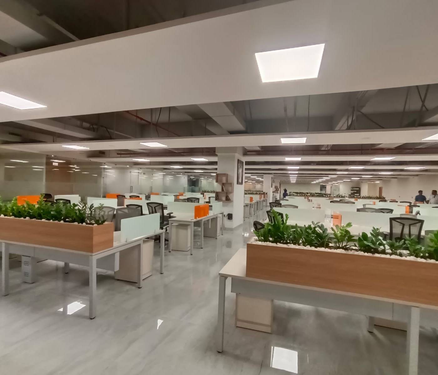 Open-plan office with built-in planters — commercial fit-out by Noor Al Sundus Contracting, Dubai