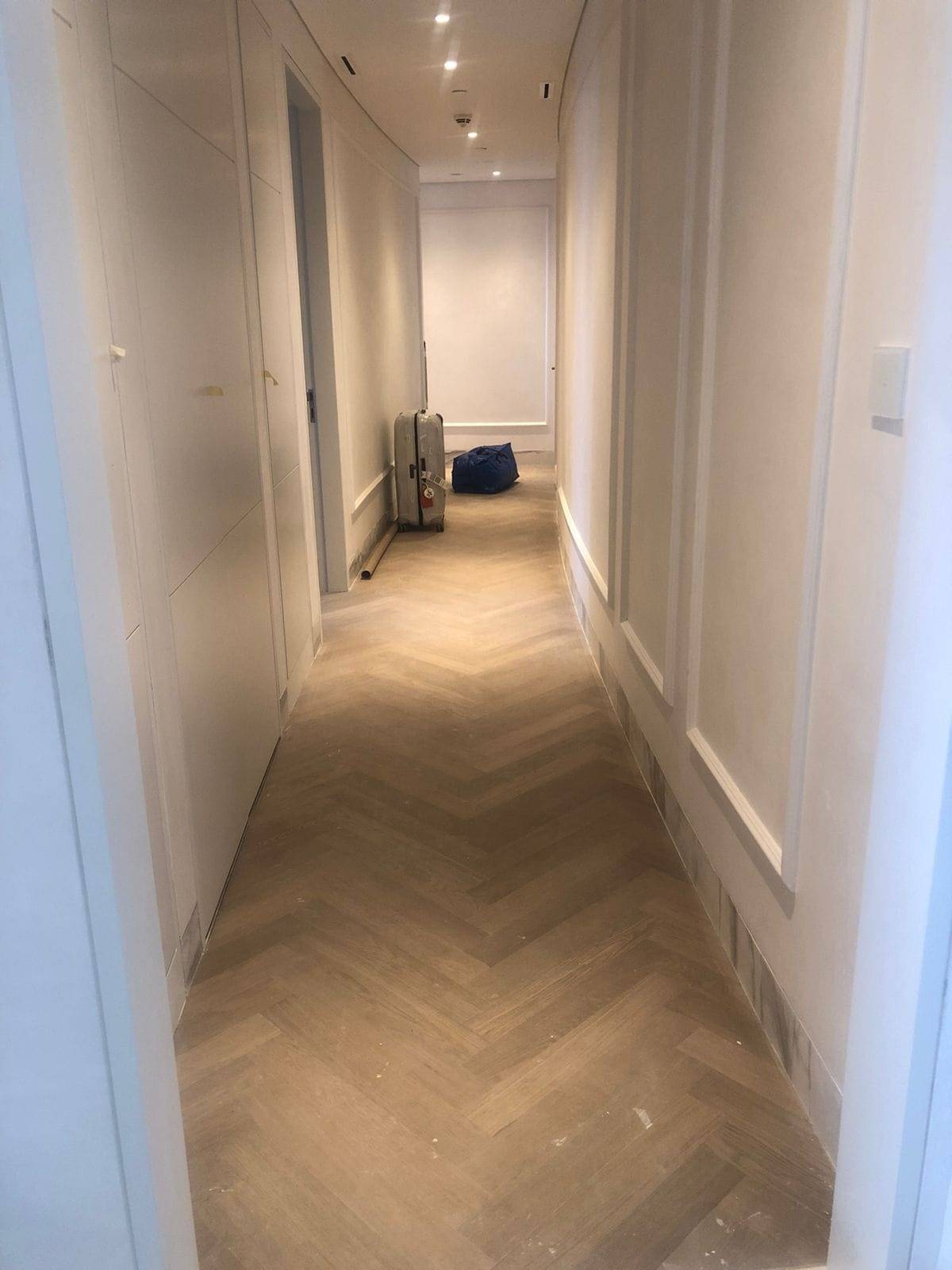 Corridor with herringbone flooring — commercial fit-out by Noor Al Sundus Contracting, Dubai
