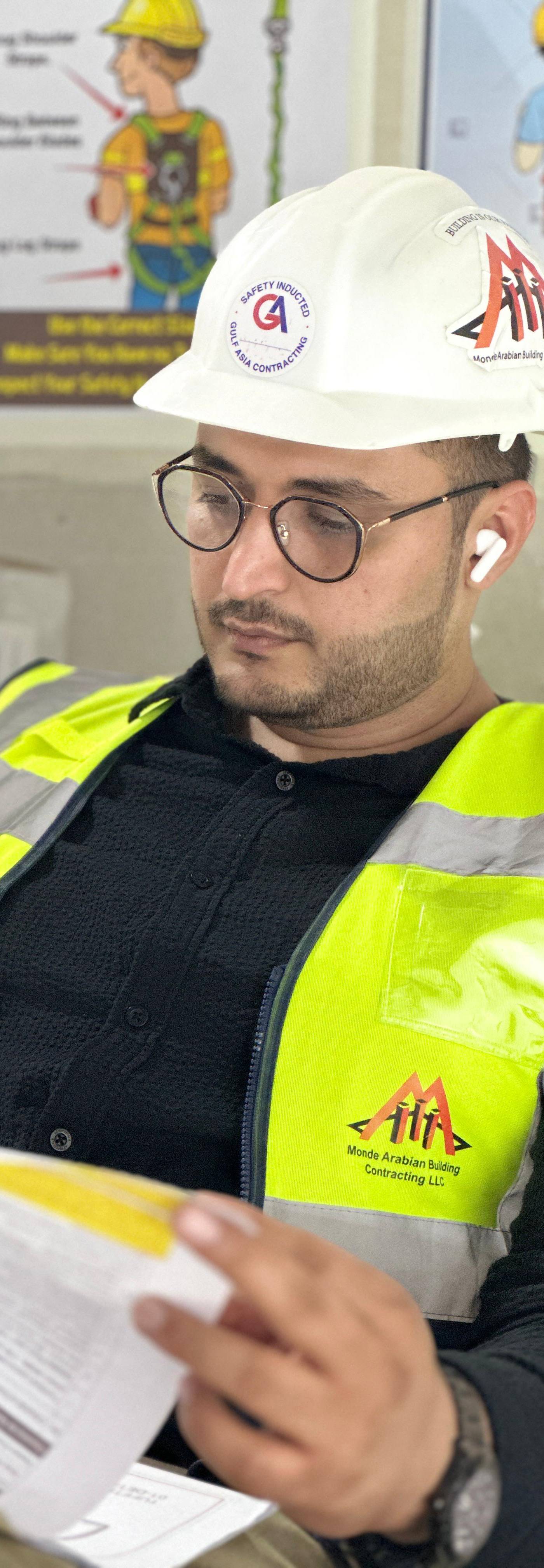 Monde engineer reviewing project documents on site — scope and planning