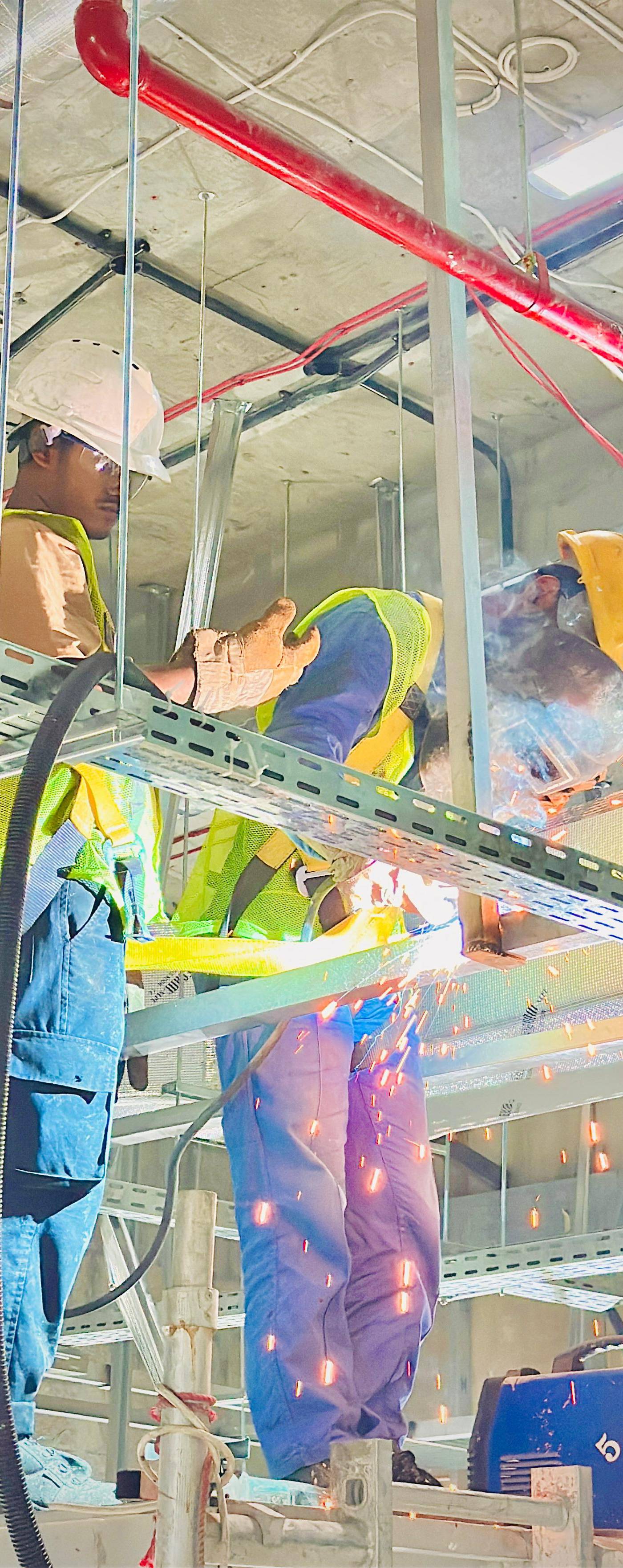Monde workers welding on site — in-house tradesmen, not subcontractors