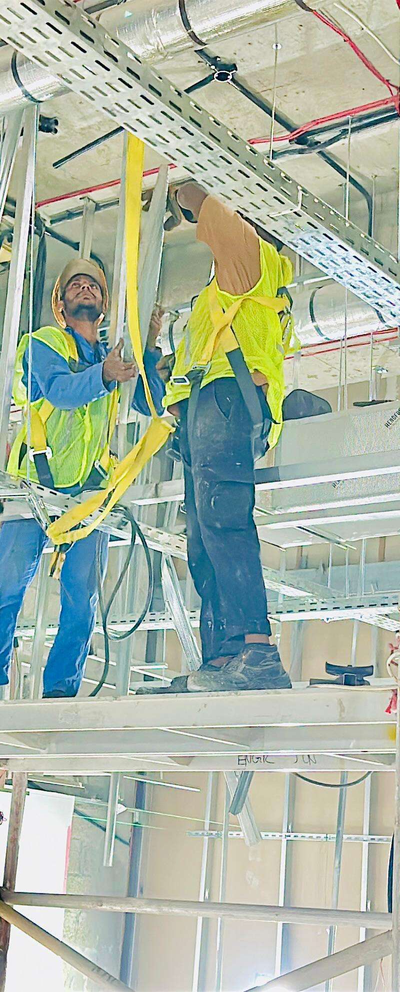 Workers installing cable trays during fit-out
