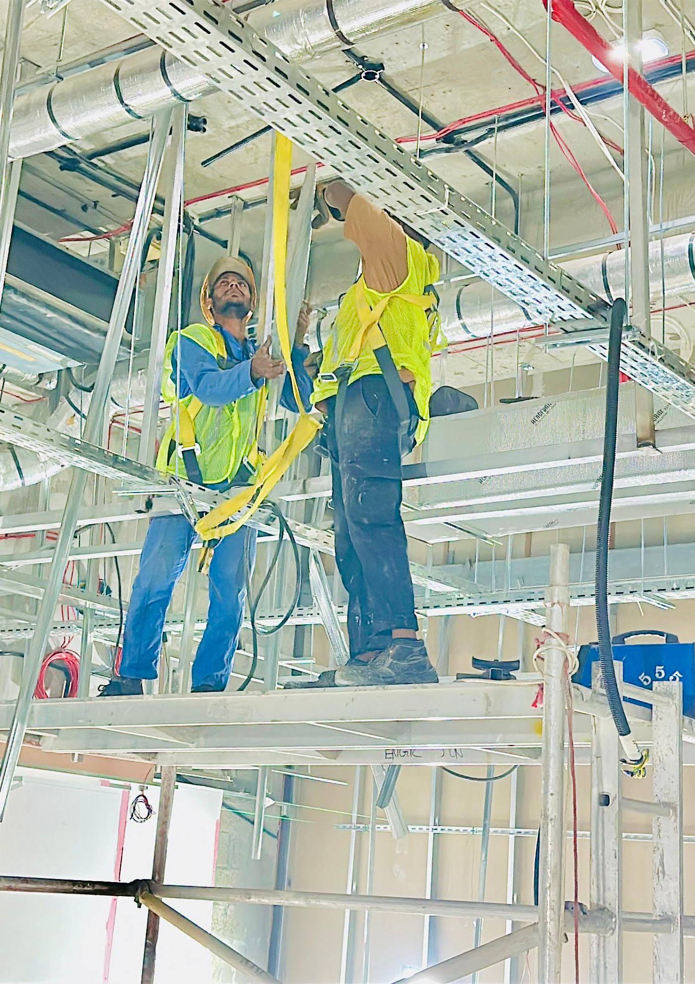 Monde’s in-house specialists installing MEP services during a commercial office fit out in Dubai, ensuring cost efficiency through direct workforce