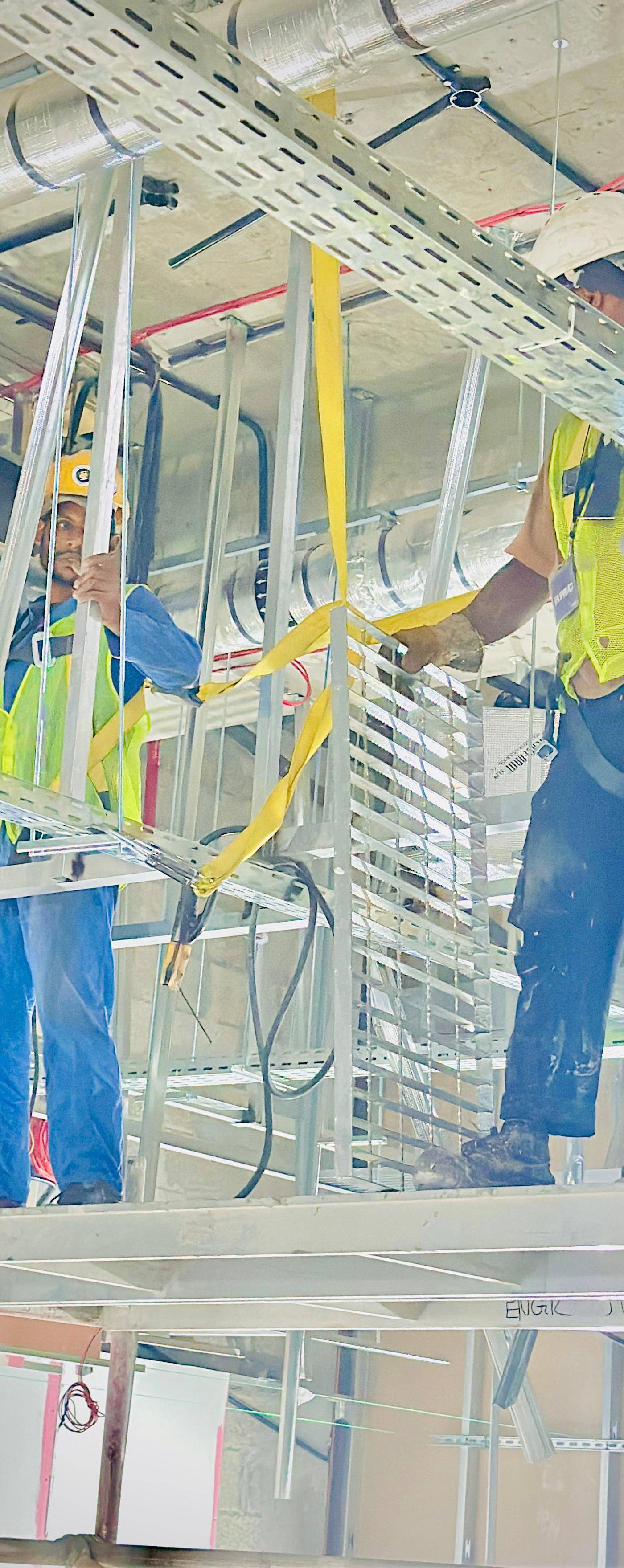 Workers installing HVAC and electrical infrastructure during a restaurant renovation project in Dubai