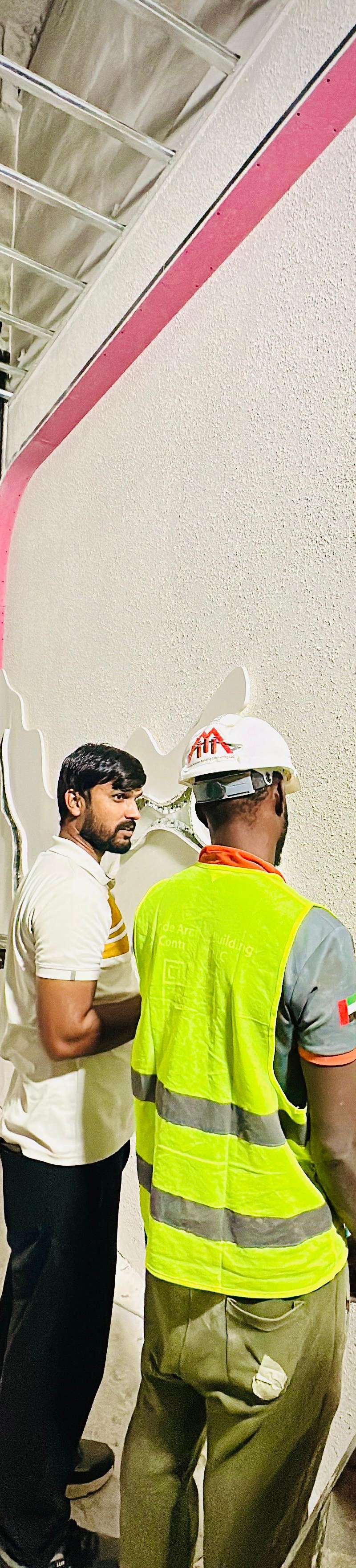 Construction crew inspecting wall installation