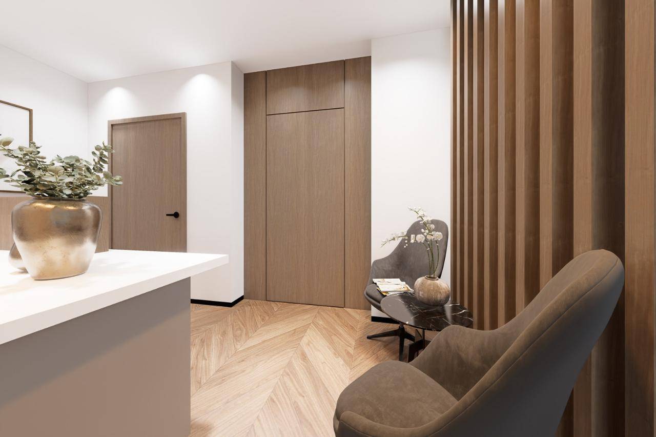 Modern renovated kitchen with warm wooden cabinetry and marble backsplash — Monde commercial fitout UAE