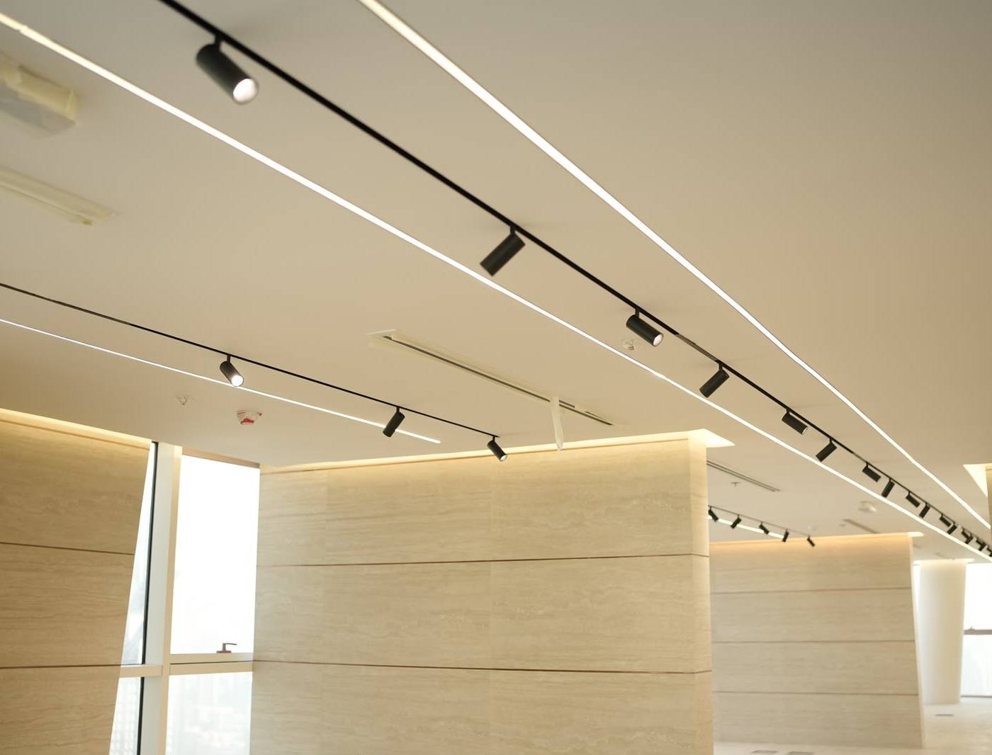 Wide-angle commercial interior showing false ceiling, LED lights, and stone walls by Monde commercial <a href=