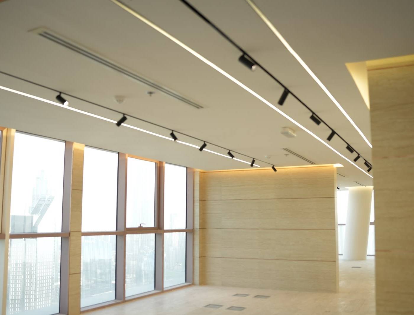 Bright renovated Monde office interior with large windows and linear LED ceiling lights, used to show the outcome at a typical office interior fit out cost Dubai level
