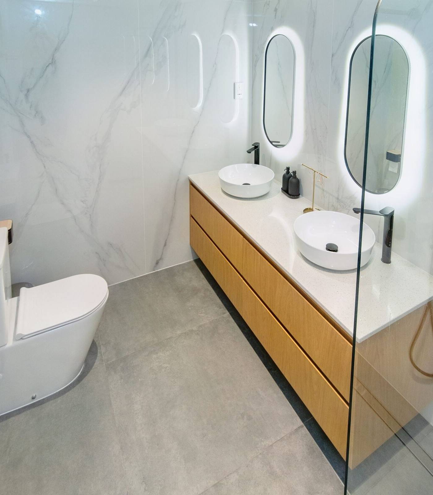 Oak double vanity in full marble bathroom fit-out