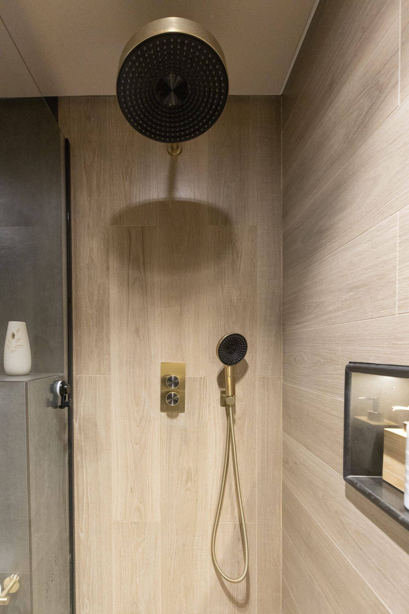 Brushed brass rain shower detail