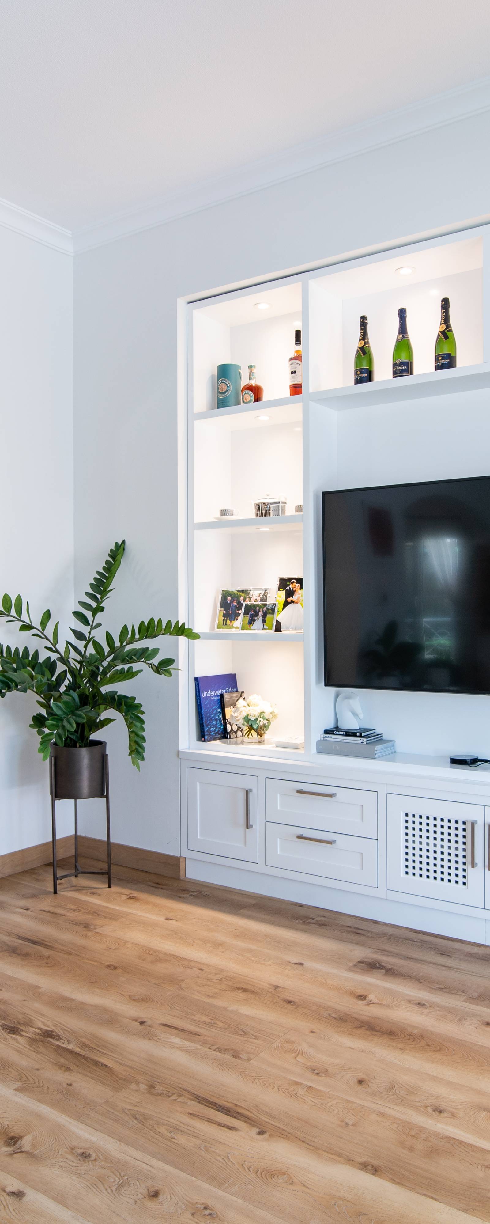 Bright modern living room with custom built-in media unit and large windows
