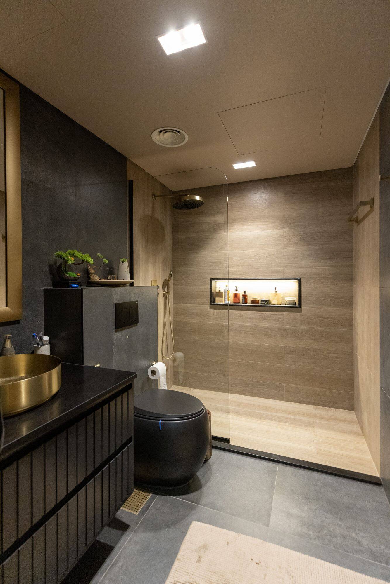 Dark bathroom suite with gold basin vanity