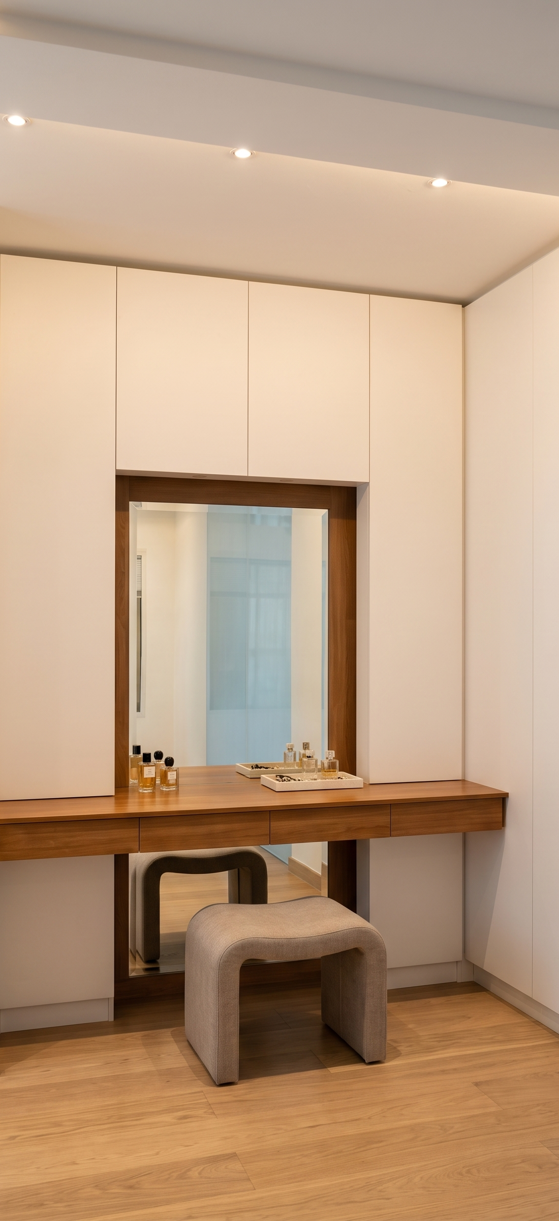 Dressing vanity in walnut with a framed mirror and stool