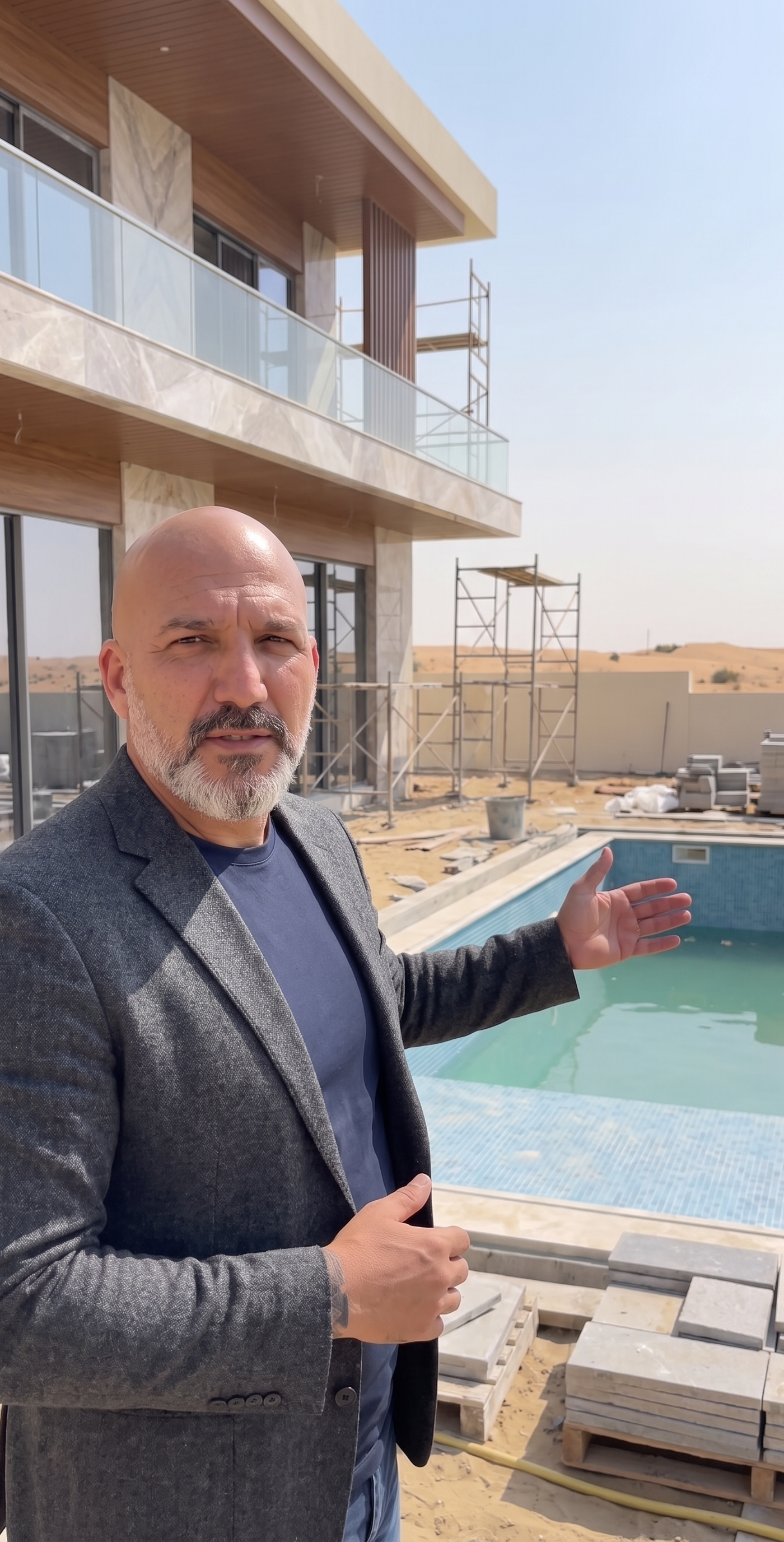 High end villa renovation Dubai site visit with project manager reviewing pool and structure