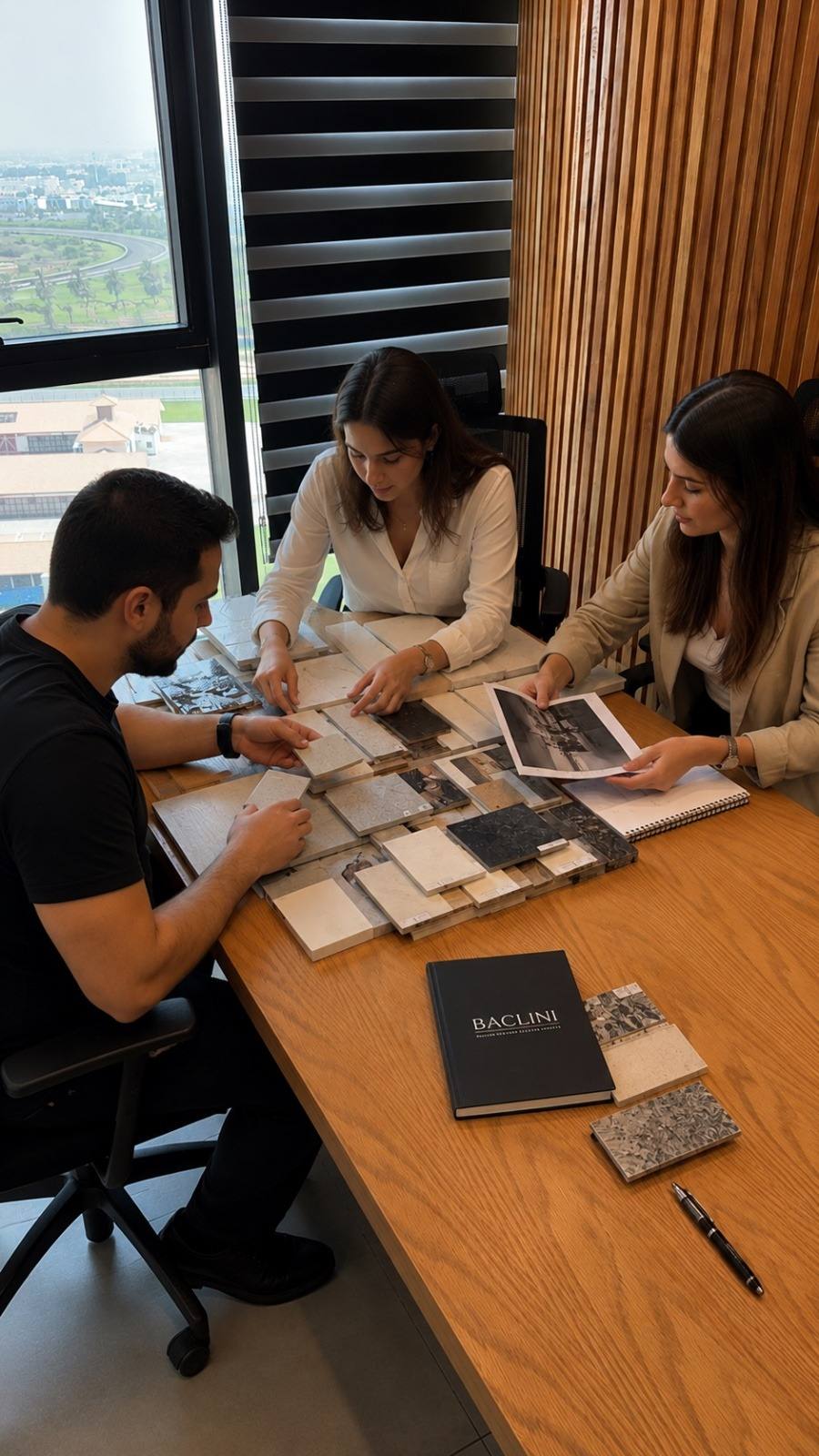 Chadi Baaklini's design team selecting stone and tile samples in the Dubai studio