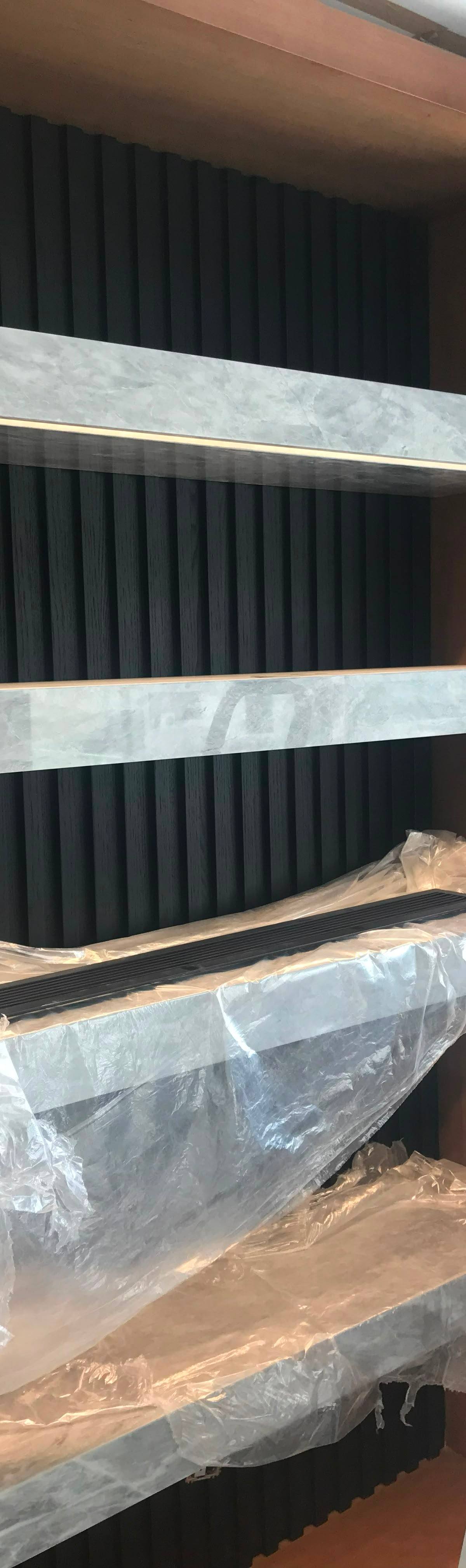 Fluted wall with marble shelves — during the build