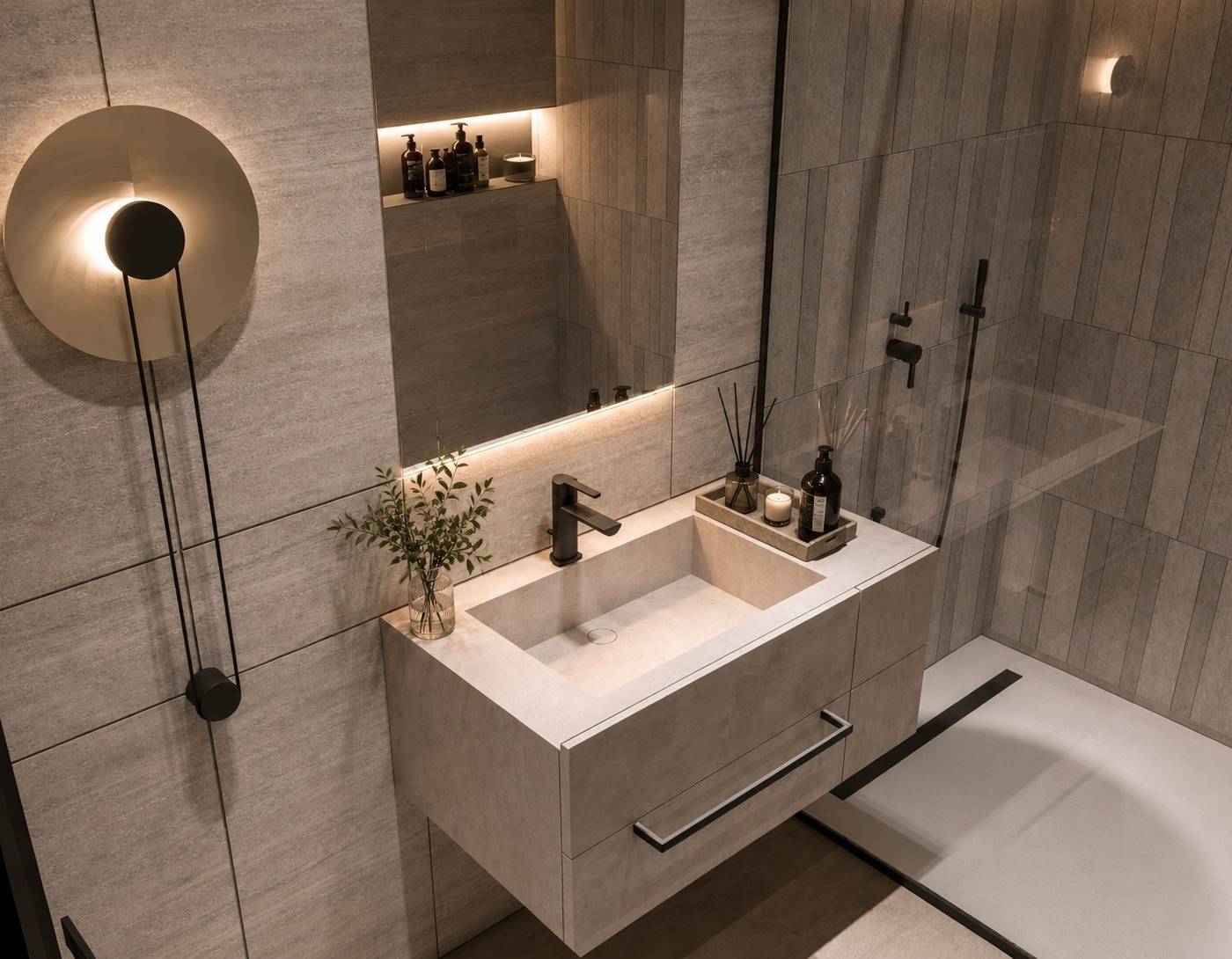 Modern Dubai villa bathroom with a floating concrete-look vanity, round wall light, matte black fixtures and a glass-partitioned shower