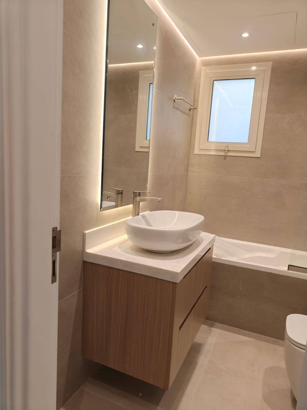Bathroom fitted out by Lacasa Line — floating vanity and backlit mirror