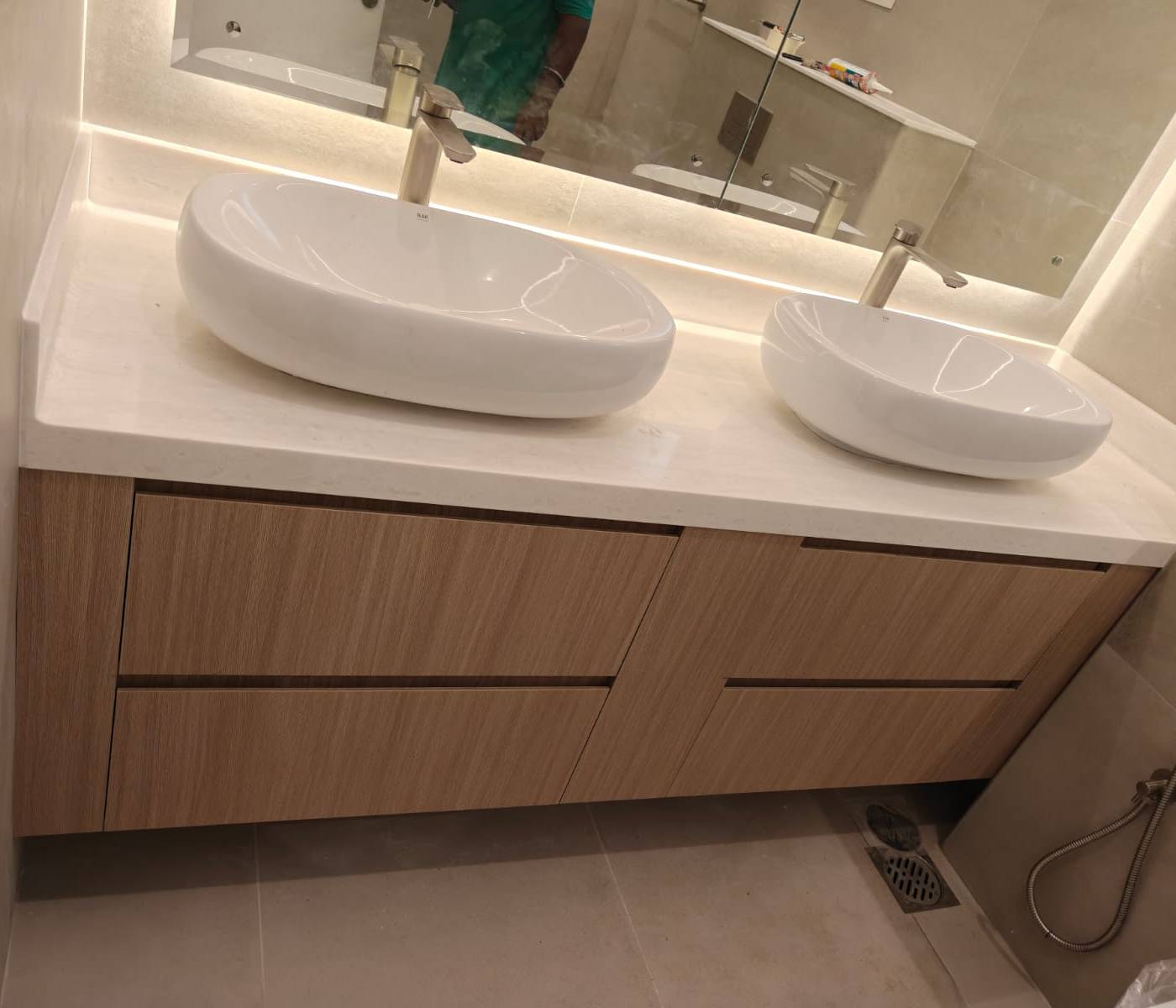 Turnkey villa renovation Dubai bathroom with floating double vanity and light wood cabinetry with LED mirror lighting