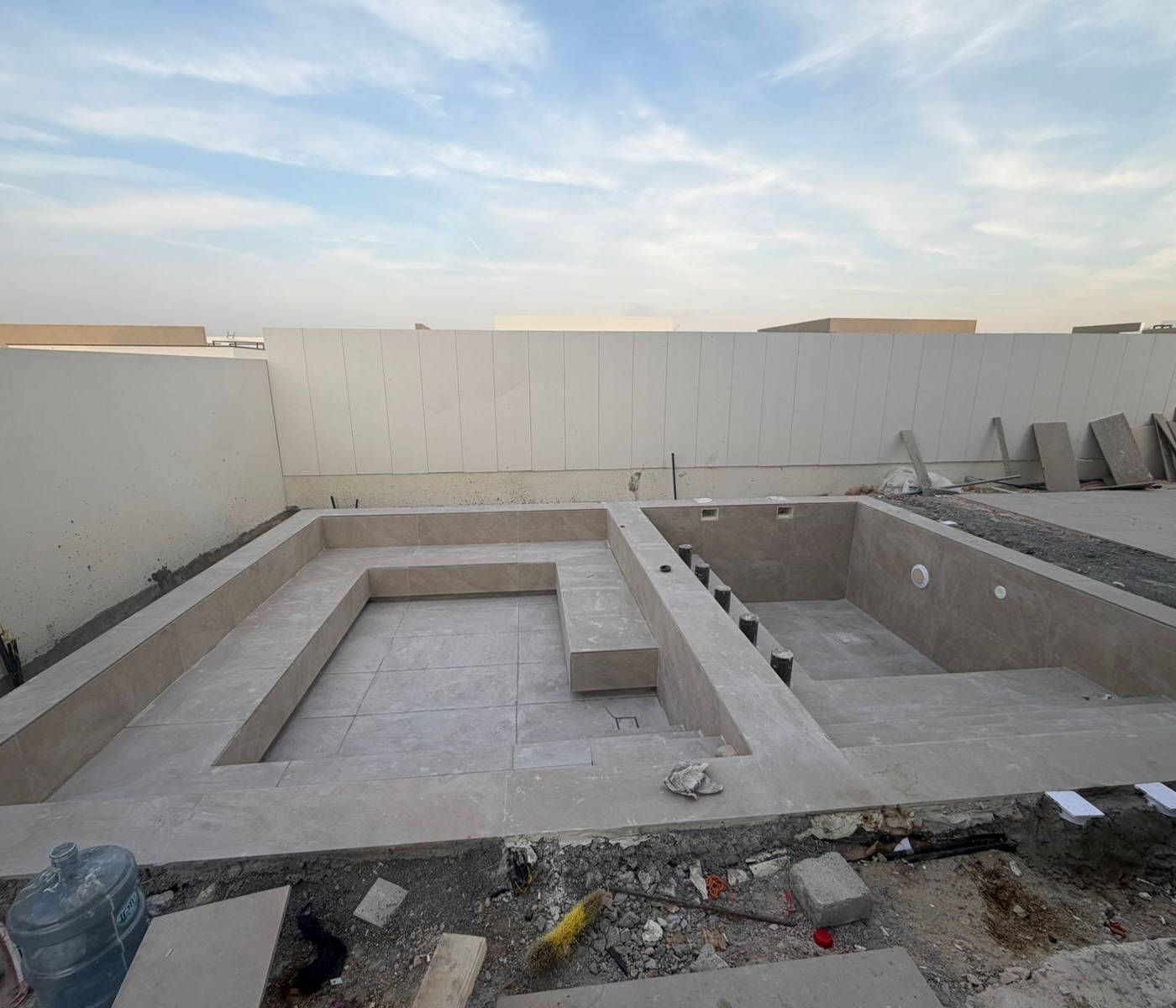 Before — raw concrete pool shell