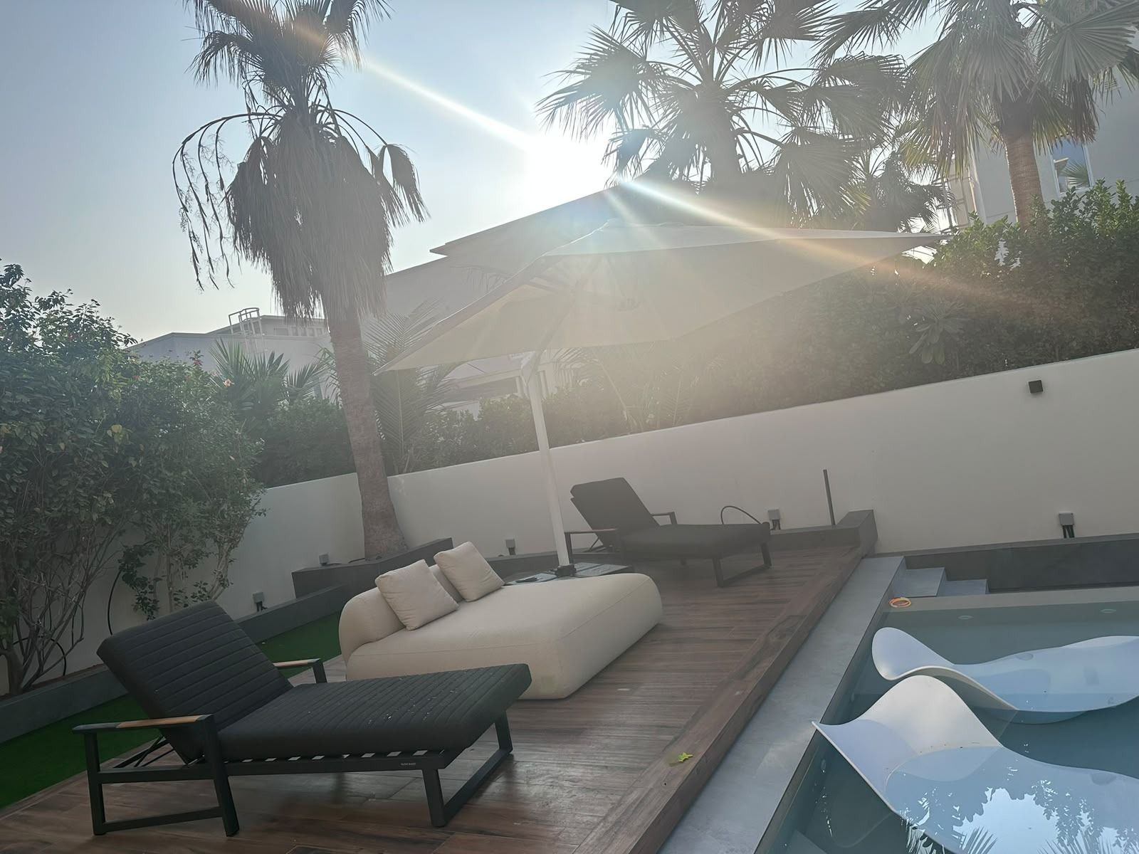 Pool deck with in-water loungers and a lounge area
