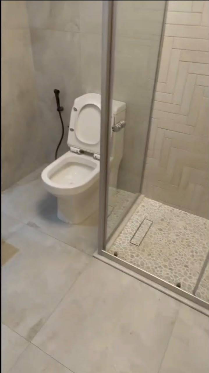 Finished bathroom with glass shower screen and new sanitaryware — after